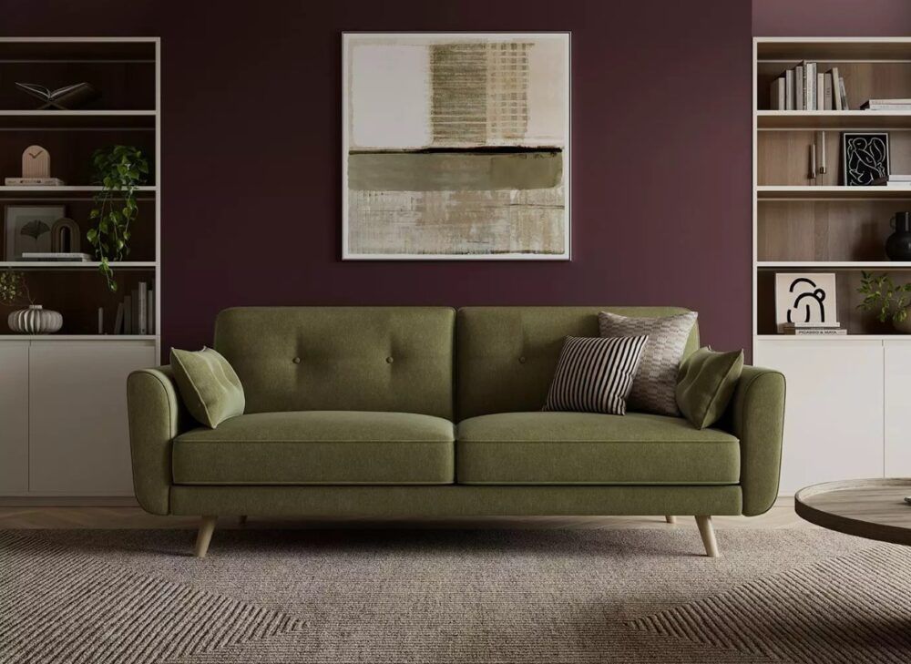 Ballymena sofa bed in green against burgundy walls